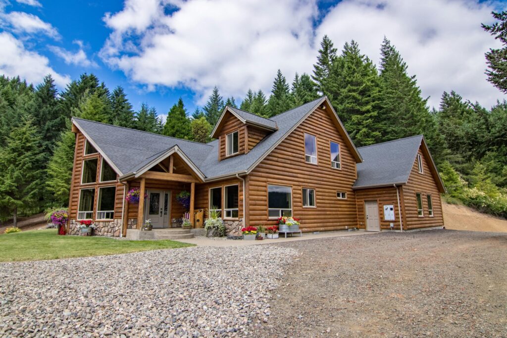 brown wooden house surrounded by green trees